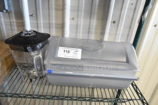 TableCraft paper product roll dispenser and blender pitcher on metal shelf. Dispenser labeled with auction tag. Good condition.