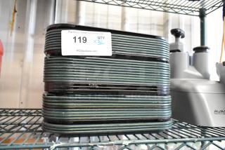 Stack of 36 poly food trays on a metal shelf, each tray in used condition. Auction label with quantity noted as x36.