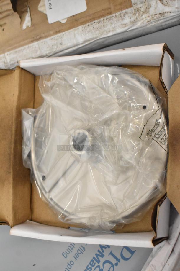 AvaMix food processor parts in box, includes continuous feed head, grating, and slicing blades, sealed in packaging.