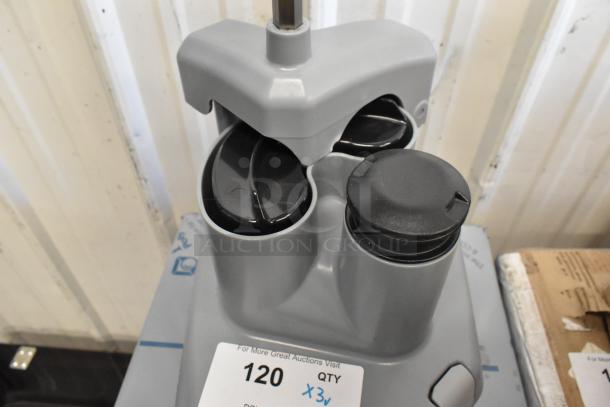 AvaMix food processor accessories including a continuous feed head, grating blade, and slicing blade with auction label.