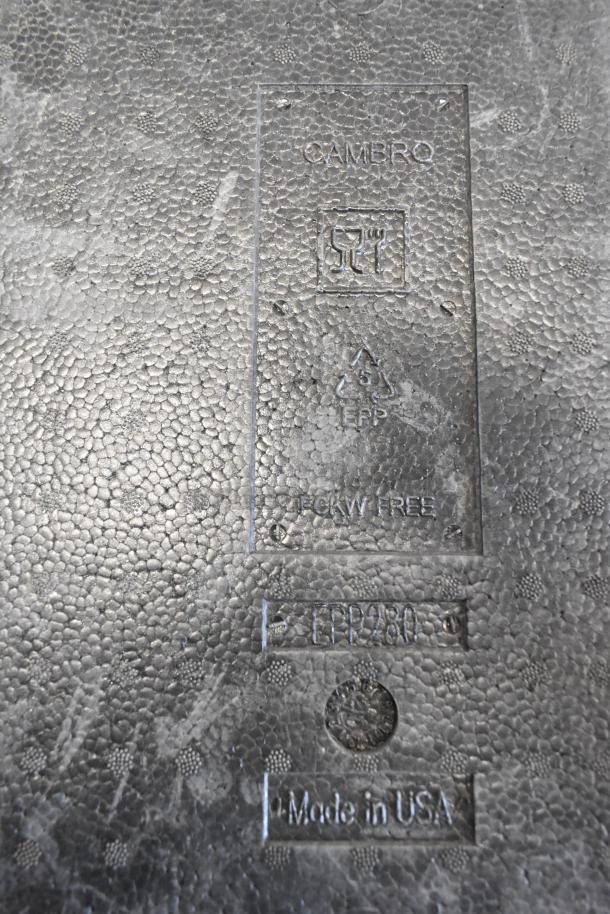 Cambro Black Insulated Portable Cooler, embossed label showing "EPP", "Made in USA", and "CFCW Free". Textured surface.