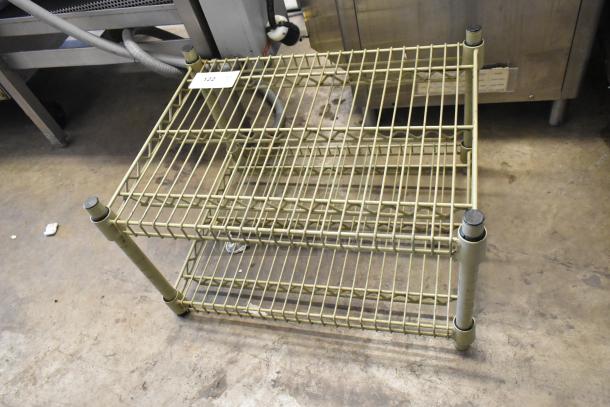2 Tier Wire Shelving Unit in used condition, featuring two metal wire shelves with reinforced posts, visible item tag "122".