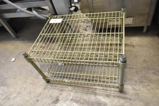 2 Tier Wire Shelving Unit in used condition, featuring two metal wire shelves with reinforced posts, visible item tag "122".