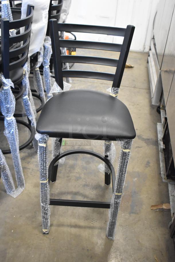 Black ladder back bar-height chair with cushion, Lancaster Table & Seating 164BMTLADFRN, wrapped in protective material.