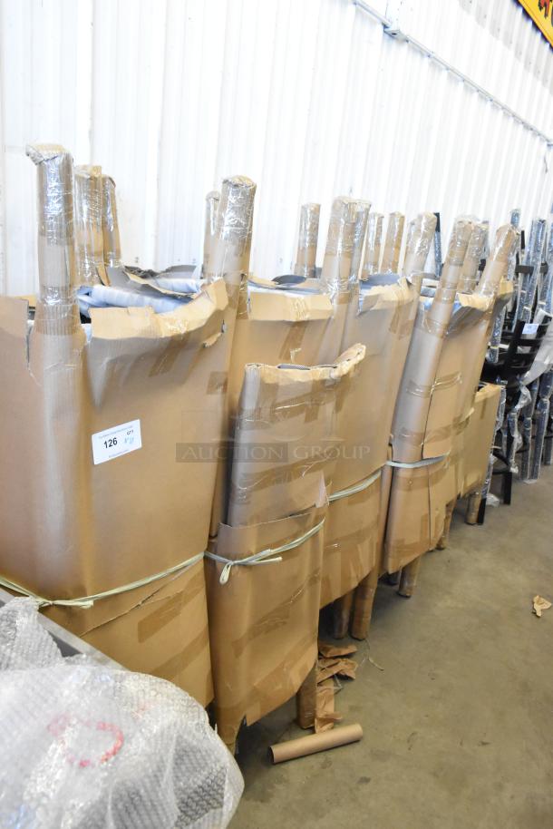 11 new scratch and dent Lancaster Table & Seating black ladder back bar chair frames, wrapped in cardboard and tape, ready for auction.