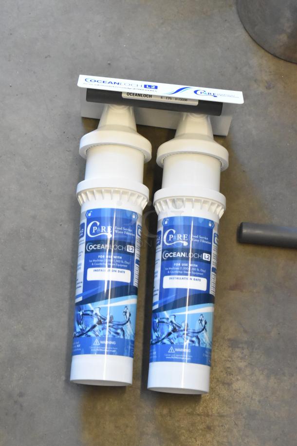 Brand new C Pure Oceanloch+ L2 dual water filtration system, includes 1 micron cartridges, outlet pressure gauge, 3.34 GPM.