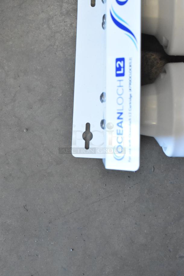 Brand new C Pure Oceanloch+ L2 dual water filtration system, includes L2 cartridges, outlet pressure gauge, 1 micron rating, 3.34 GPM.