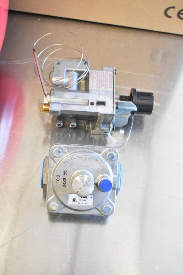 Brand new Avantco 177KNOBTAGCS knob and RV48L gas hookup piece on metallic surface; Maxitrol marking visible.