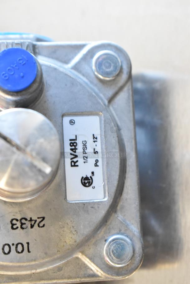 Brand new RV48L gas hookup piece, metal with visible marking “1/2 PSIG” and certification logos. Included in auction lot.
