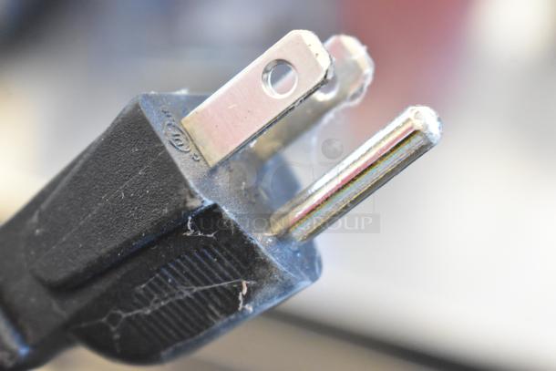 Close-up of a power plug for a 2023 VitaMix VM0197A Blender, 120 volts, 1 phase. Minor wear visible.