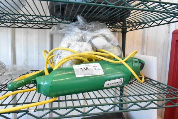 Brand new Bissell BGST1566 BigGreen Power Steamer, 115V, scratch and dent, green with yellow cord, auction tag visible.