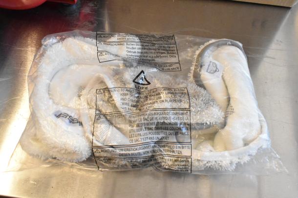 Sealed Bissell BGST1566 mop pads in plastic bag with safety warnings. New condition, part of BigGreen Commercial Power Steamer set.
