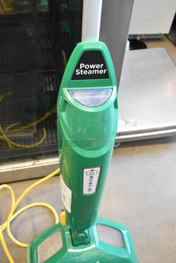 Brand new Bissell BGST1566 BigGreen Commercial Power Steamer, 115 Volts, 1 Phase. Green, with visible scratch and dent markings.