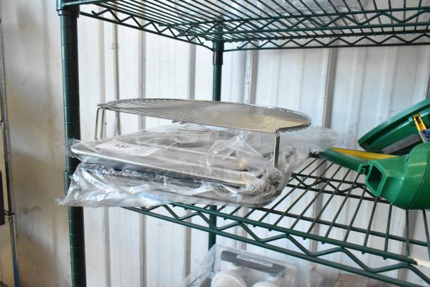 3 Nordic Ware Naturals aluminum sheet pans and wire rack packaged on metal shelf, brand new with packaging visible.