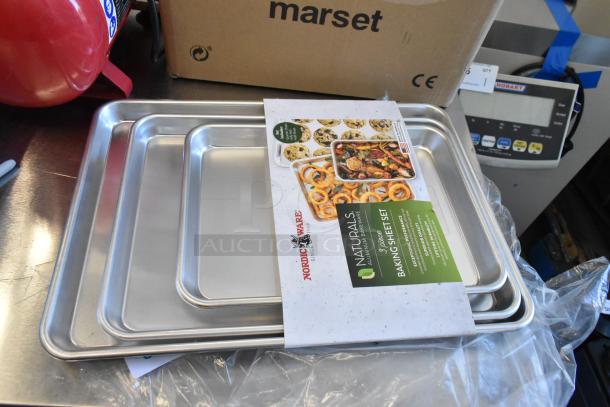 Nordic Ware Naturals 3-piece aluminum baking sheet set with packaging. Brand new, includes 20 gauge wire in rim for durability.
