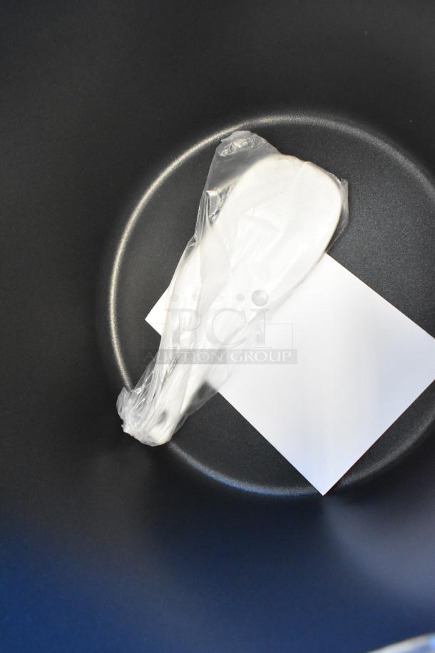 Avantco 177RWB92 rice warmer interior showing a wrapped scoop and document. Brand new, 92 cup capacity, electric.