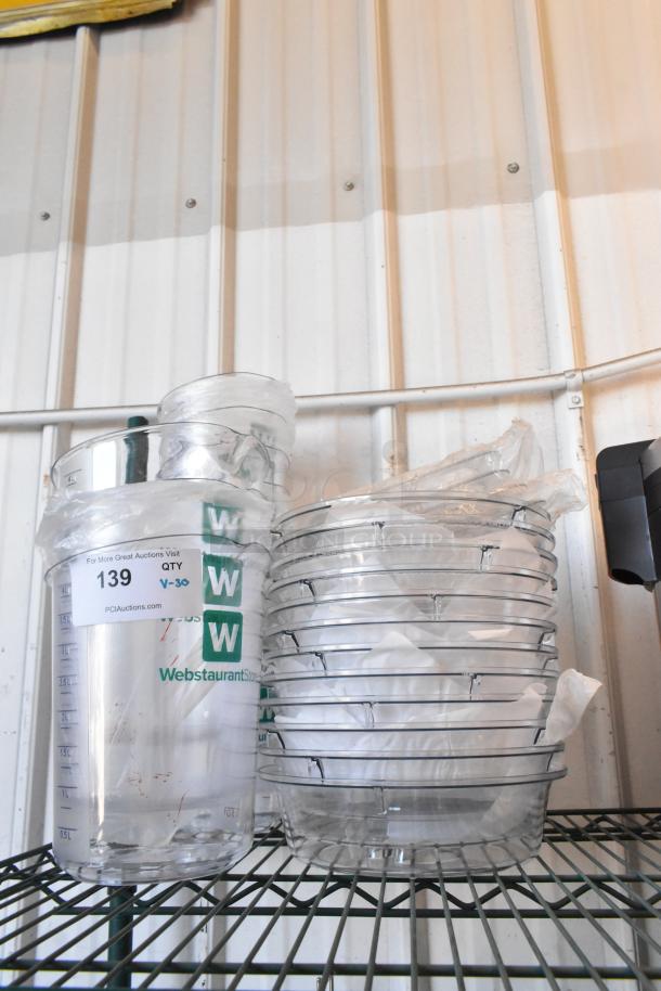 Lot of 30 brand new clear poly bins with accompanying dome lids, some with minor scratches. Labels read "WebstaurantStore."