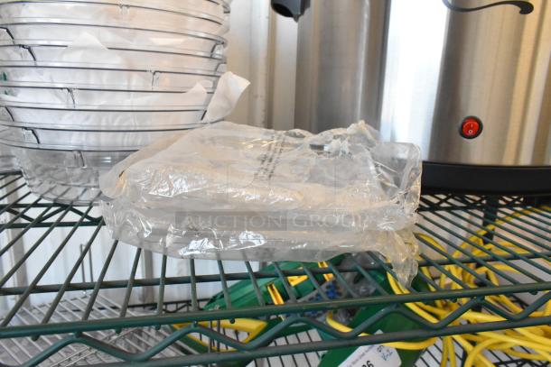 Lot of 30 clear poly bins with dome lids, brand new but with visible scratches and dents, packaged in plastic.