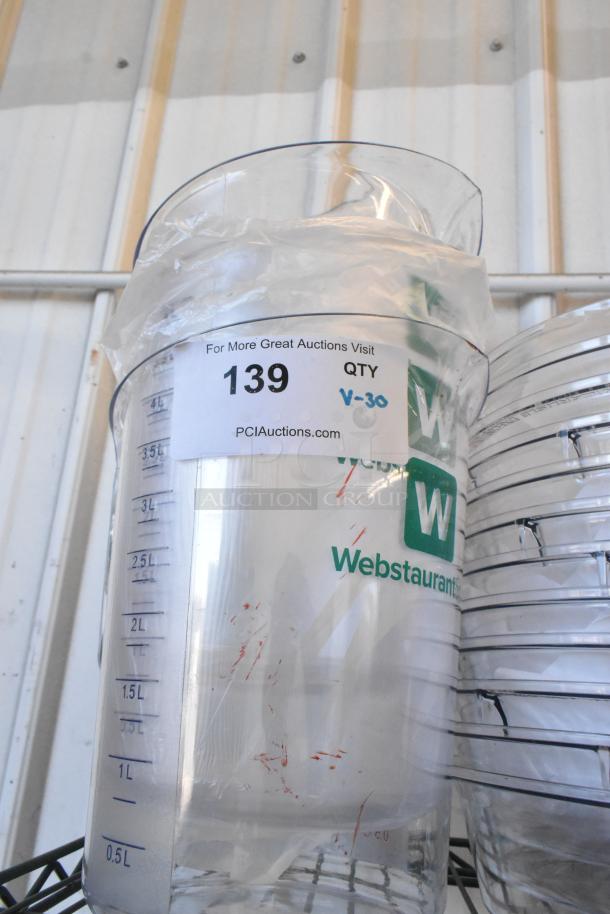 Lot of 30 new clear poly bins and dome lids with measurement markings and slight scratches. WebstaurantStore branding visible.