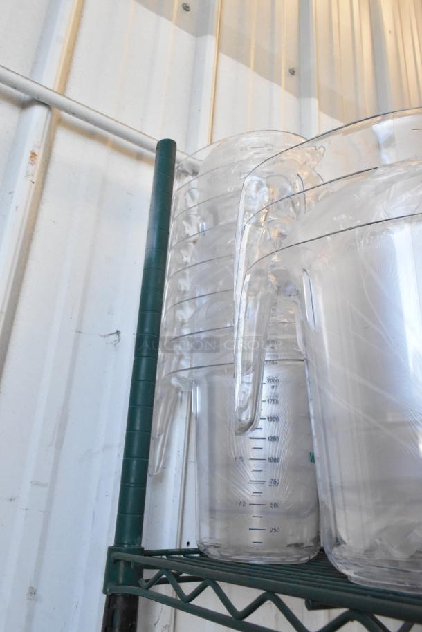 Lot of 30 clear poly bins with dome lids, new with minor scratches. Stackable, transparent construction for easy visibility.