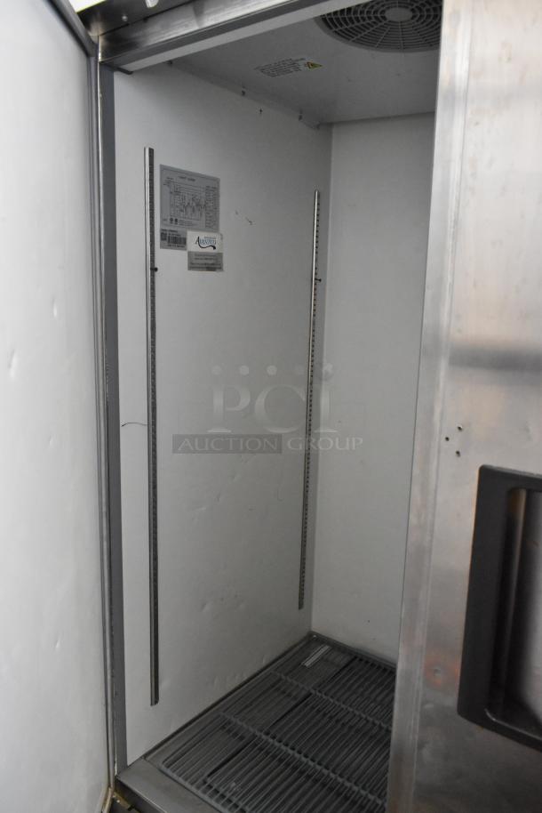 Avantco 178A49FHC stainless steel 2-door reach-in freezer interior, featuring poly-coated racks and commercial casters.