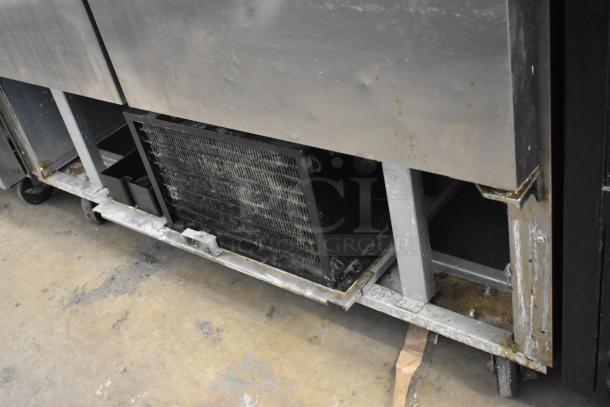 Avantco 178A49FHC stainless steel commercial 2-door reach-in freezer, visible wear, on casters, 115 volts, 1 phase.