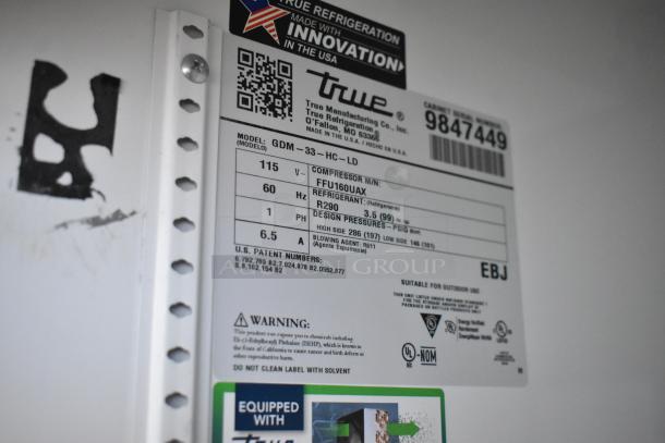 2019 True GDM-33-HC-LD commercial cooler label showing model, voltage, refrigerant, and safety warnings.