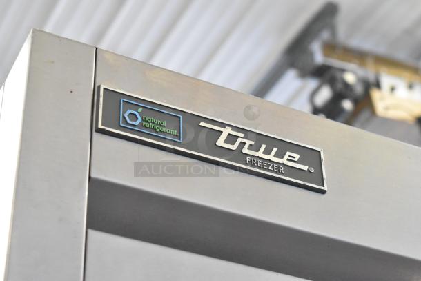 2019 True TS-23F-HC stainless steel freezer with natural refrigerant label, commercial casters, and poly-coated racks.
