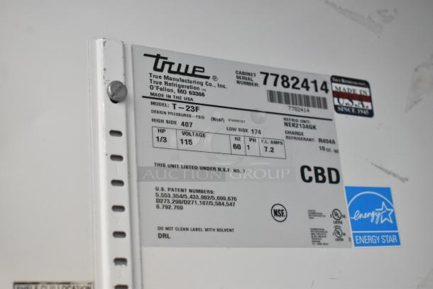 Label on True T-23F stainless steel commercial freezer, showing model, 115V, energy efficiency, and NSF certification.