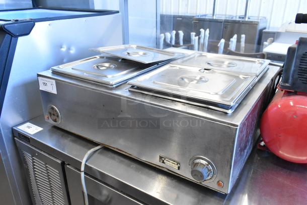 Wells TMPT stainless steel countertop food warmer, 120V, single phase, with dual controls and visible wear.