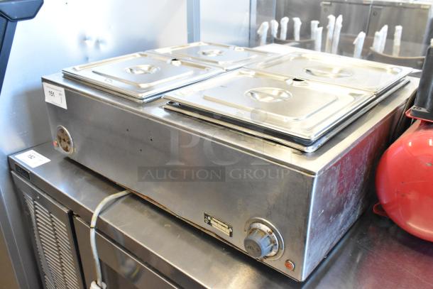 Wells TMPT stainless steel commercial countertop food warmer with four lids, 120 volts, 1 phase, used condition.