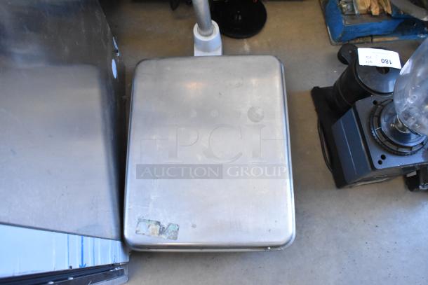 Hobart RW metal scale, showing signs of wear, with a flat weighing platform and visible markings.