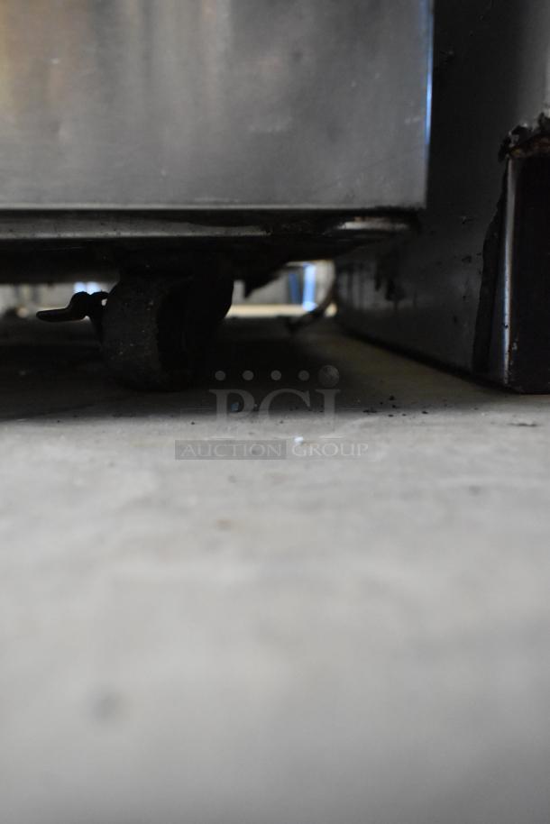 Delfield stainless steel commercial 2-door undercounter cooler with casters, 115 volts, 1 phase, shown in used condition.