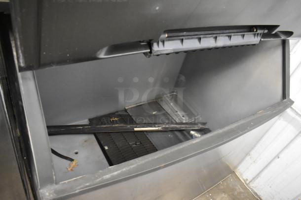 Manitowoc SD1802A stainless steel commercial ice head on bin. 208-230 volts, 1 phase. Good condition, visible interior components.