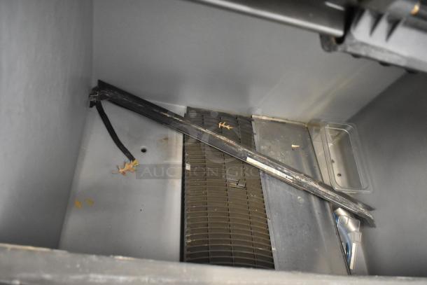 Manitowoc SD1802A stainless steel commercial ice head on ice bin; 208-230 volts, 1 phase; interior view; used condition.