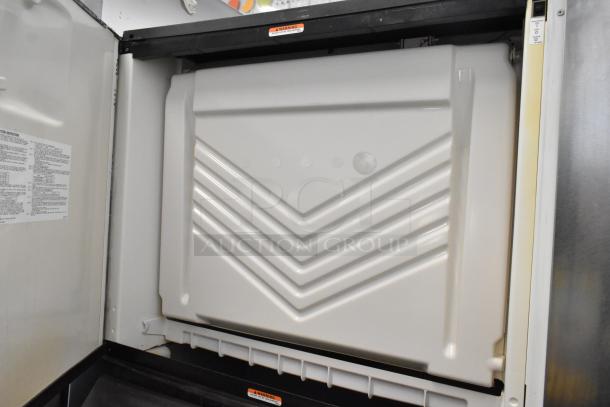 Manitowoc SD1802A stainless steel ice head on bin, commercial use, 208-230V, 1 phase, interior view with labels.