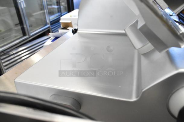 Avantco 177SL512 stainless steel countertop meat slicer with blade sharpener, 115V, in commercial kitchen setting.