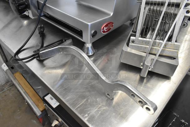 Choice 407ONSLIC316 metal commercial countertop lettuce cutter, shown on a stainless steel surface, appears in good condition.