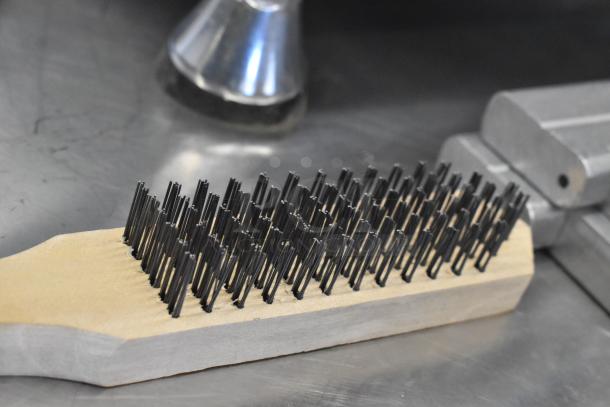 Coarse cleaning brush with wooden handle and metal bristles, ideal for heavy-duty cleaning tasks. Auction includes two items.