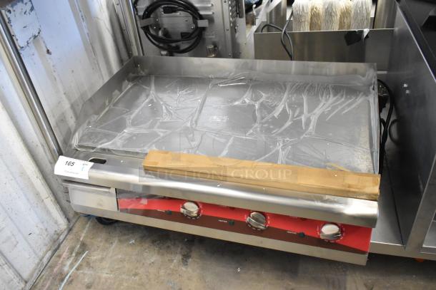 Brand new Avantco 30" stainless steel flat top griddle with packaging. Slight scratches noted. Three temperature controls.