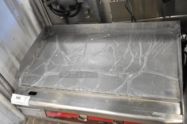 Brand new Avantco 30" flat top stainless steel griddle, with minor scratches and dents. Protective plastic still on surface.