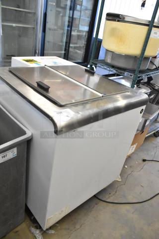 Global Metal commercial chest freezer on casters, stainless steel lid, good condition, visible inventory tags.
