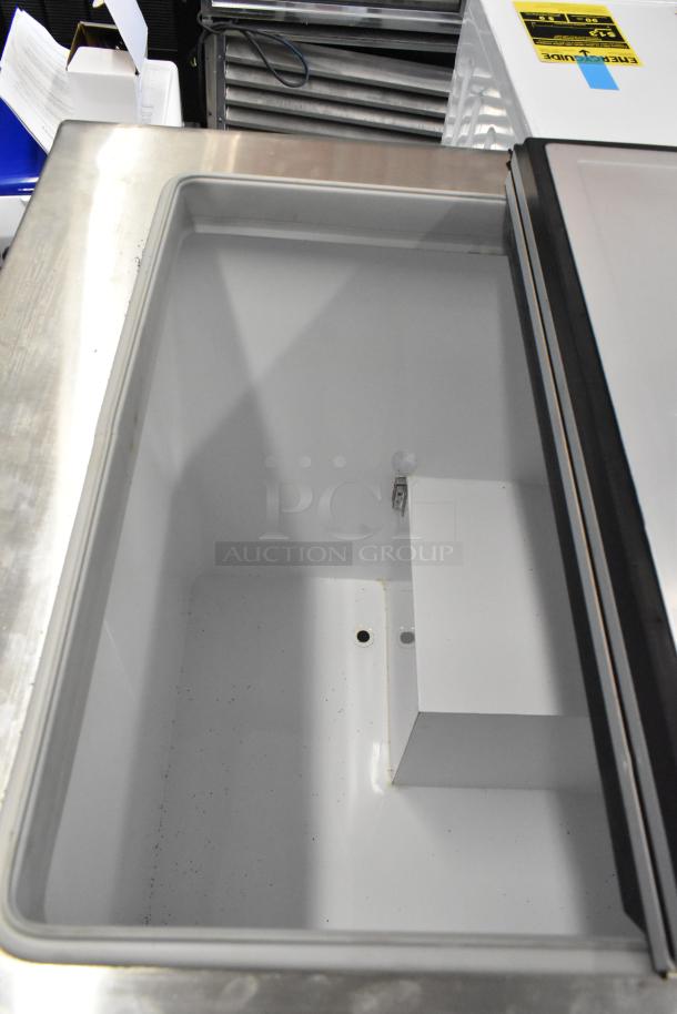 Global Metal Commercial Chest Freezer on casters, stainless steel finish, open lid, showing interior. Good condition.