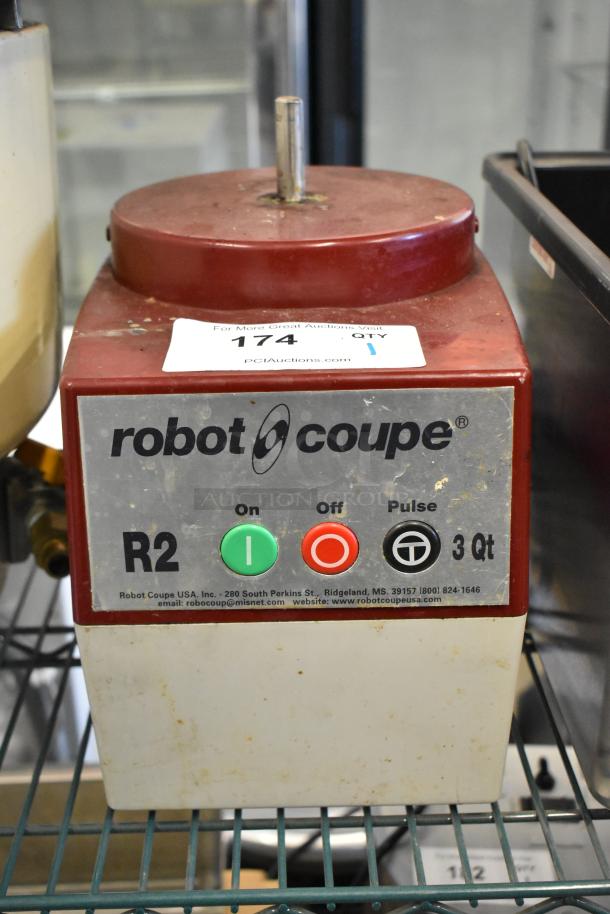 Robot Coupe R2N food processor base, 120 volts, 1 phase, red and white, used condition, with control buttons.