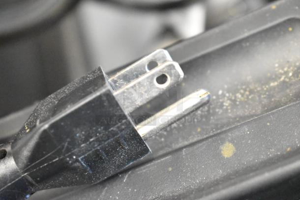 Close-up of a plug for the Server IS-1/3 countertop food warmer, 120 Volts, 1 Phase. Plug appears slightly used.