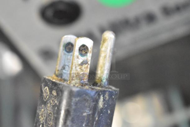 Close-up of power plug for Robot Coupe R 301 U Series D food processor, showing signs of wear and corrosion.