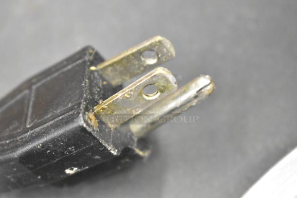 Close-up of a worn power plug for Server FSPW-SS stainless steel rethermalizer, showing signs of use, 120 volts, 1 phase.