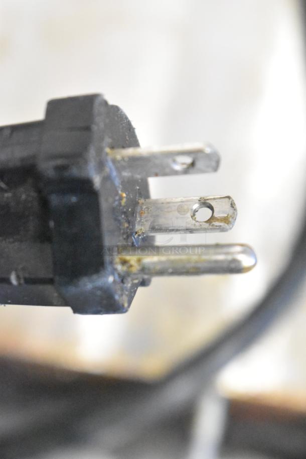 Waring WPG250B Panini Press plug, showing a standard 208V power connection, slight wear on metal contacts.