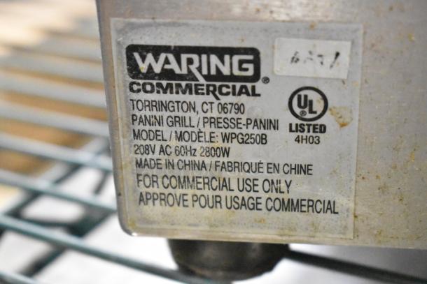 Waring WPG250B Stainless Steel Panini Press label showing model, voltage, and commercial use indication.