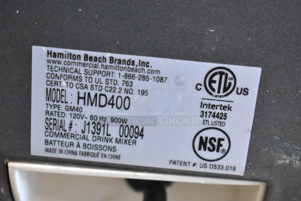 Hamilton Beach HMD400 Commercial Drink Mixer label, 120V, 60Hz, 900W; model and certification details visible.